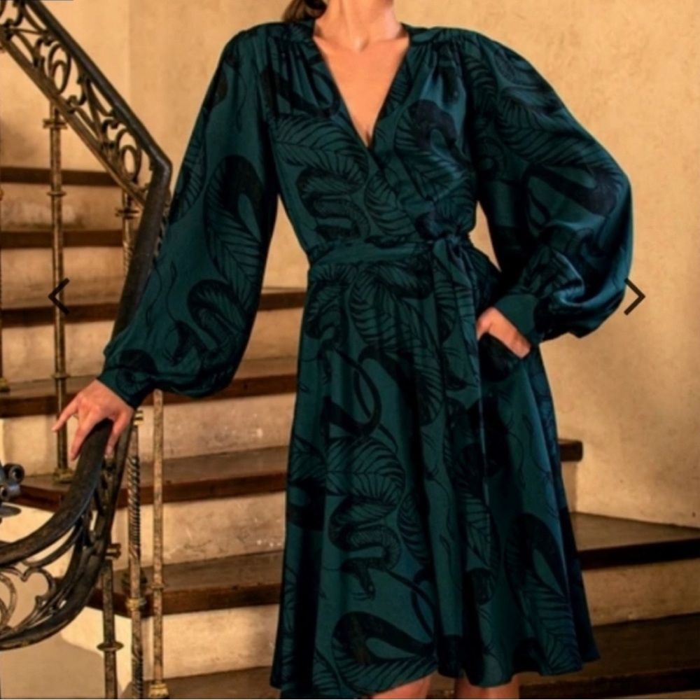 La Femme En Noir (brand) serpentine wrap dress in dark green and black.